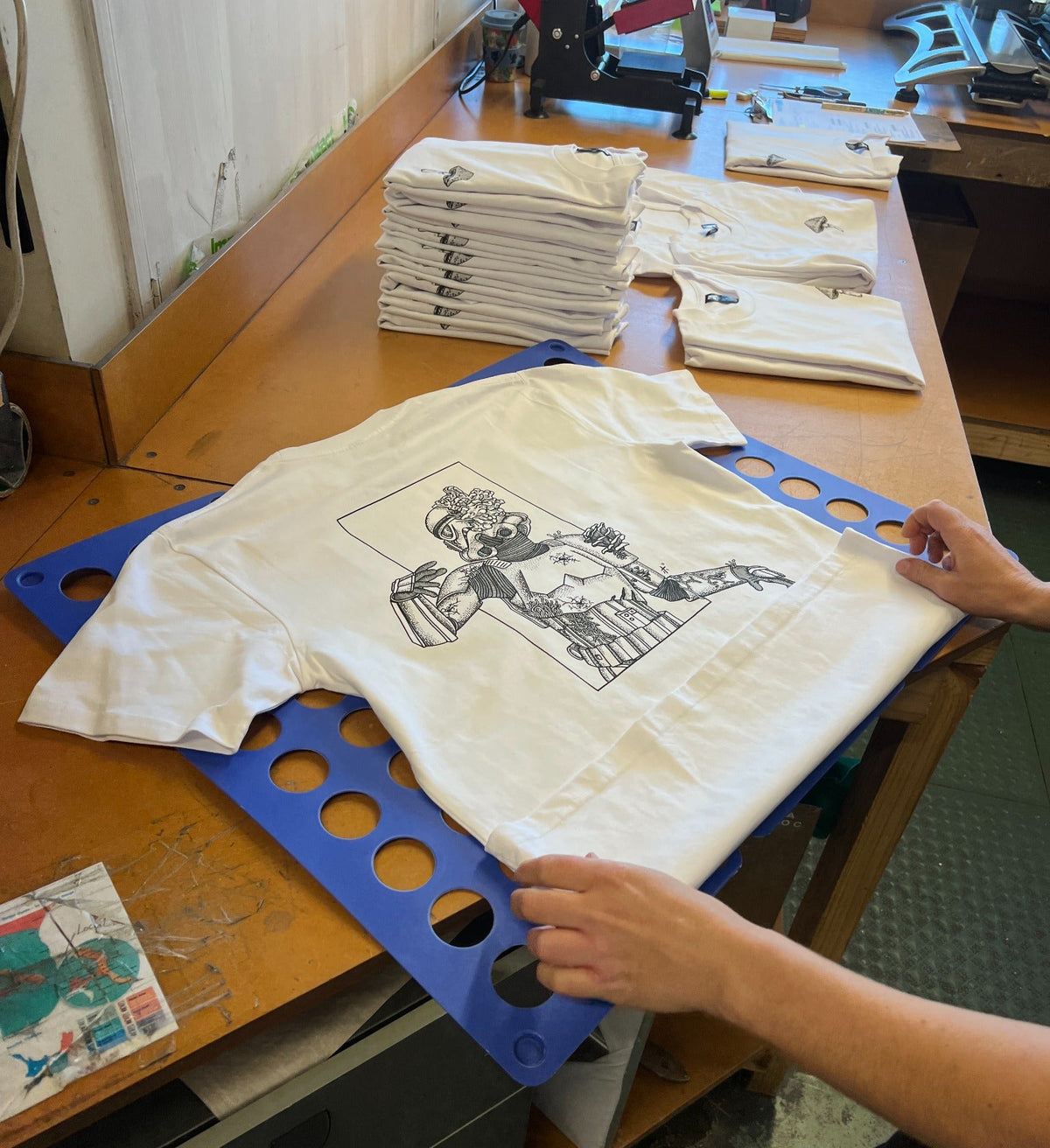 The original shirts being finished at the local printer